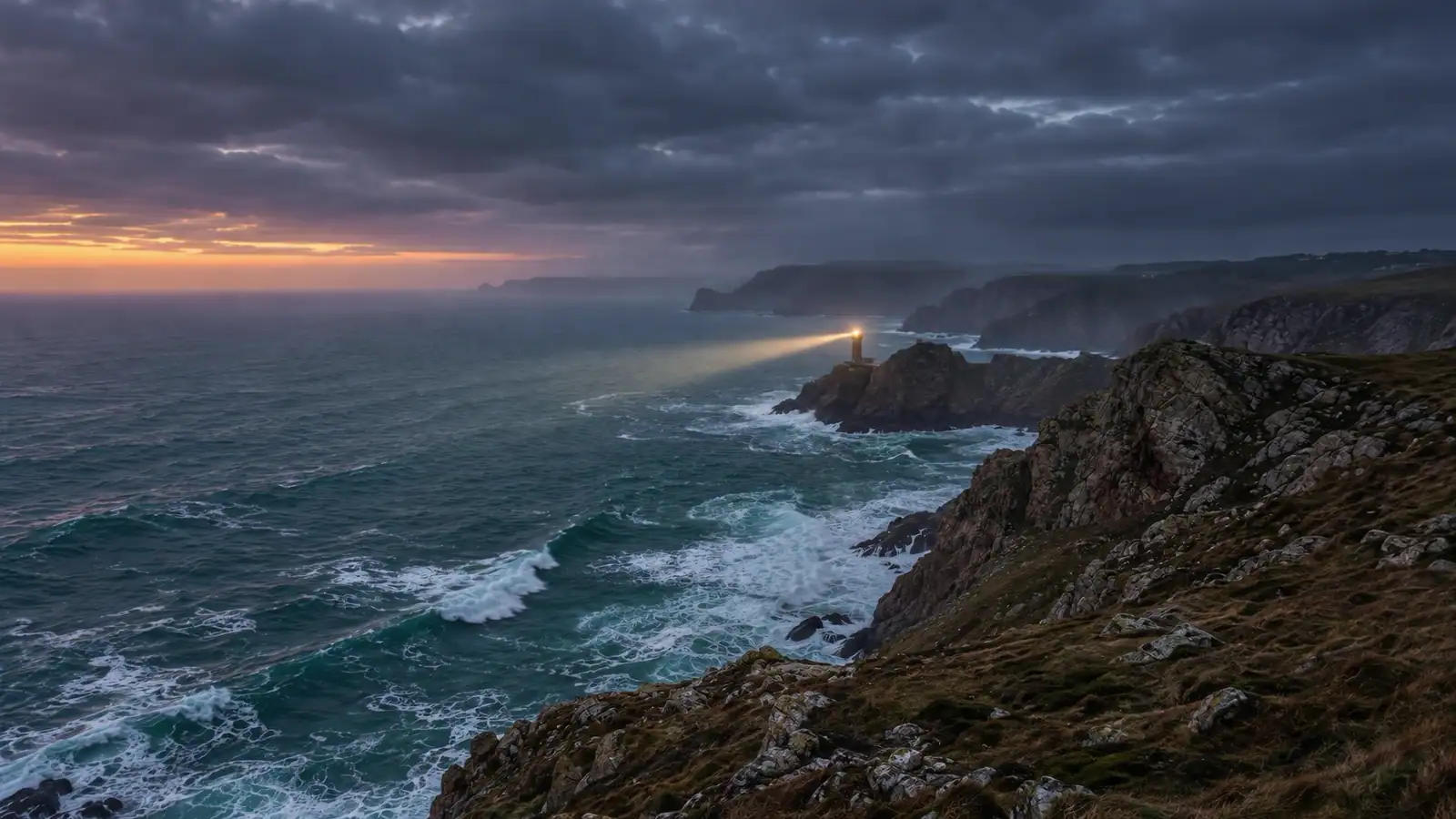 A lighthouse on a sea stack below high cliffs at dusk, its beam out over a heavy sea
